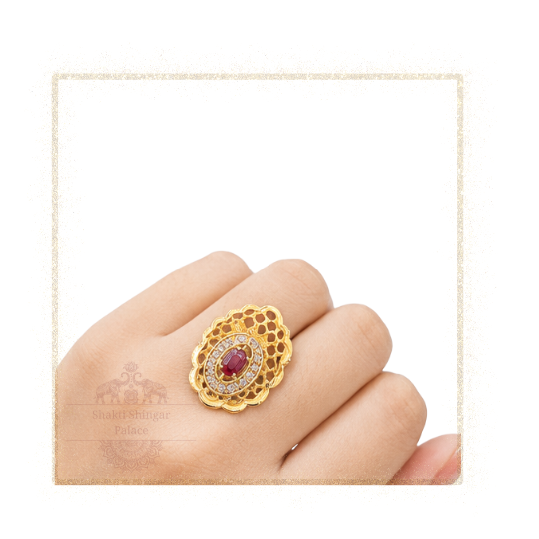 Ring SSP Women’s floral gold-plated designer ring with ruby stone and crystal detailing displayed on female hand for jewelry showcase.